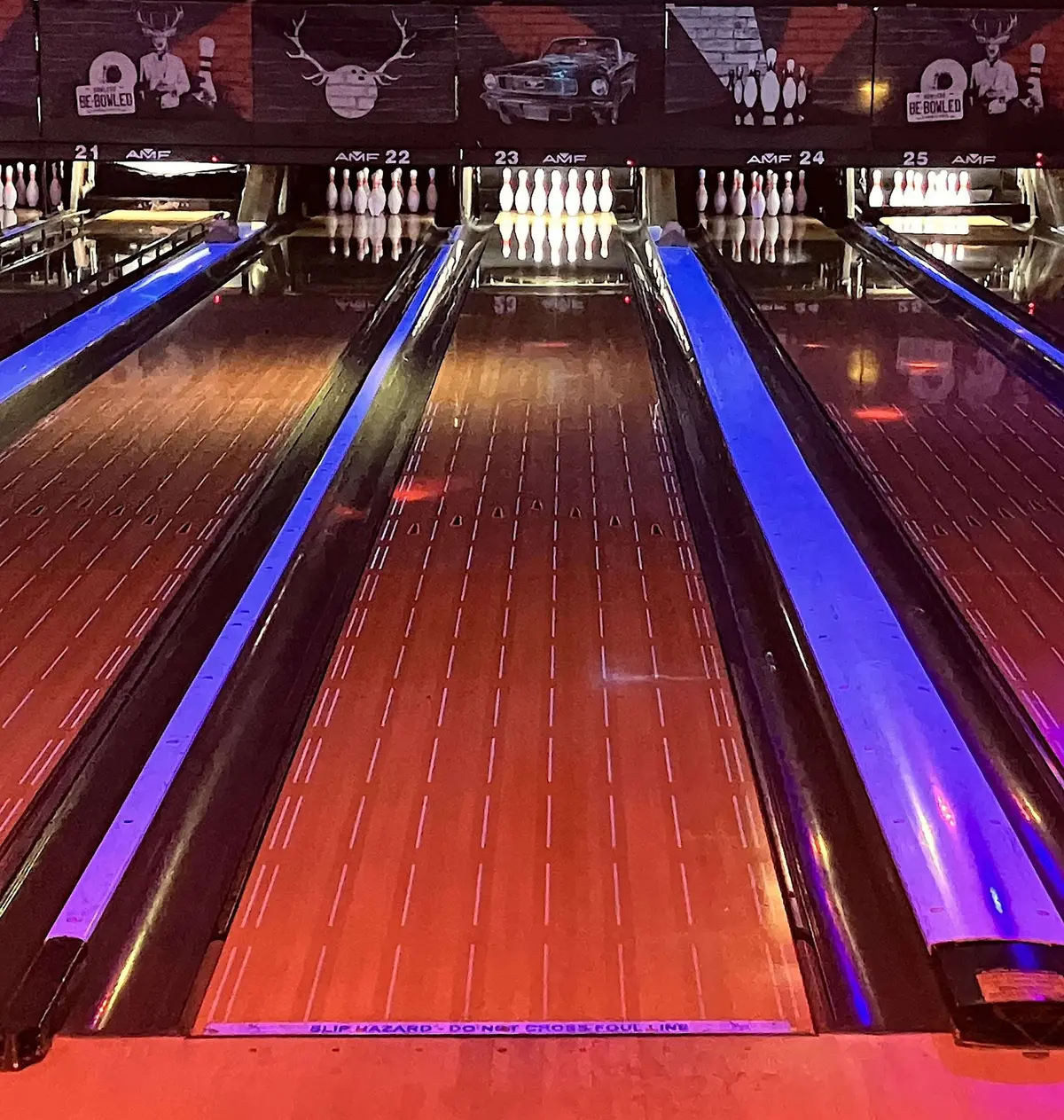 Bowlingbahnen unter Schwarzlicht, Rinnen leuchten blau und violett